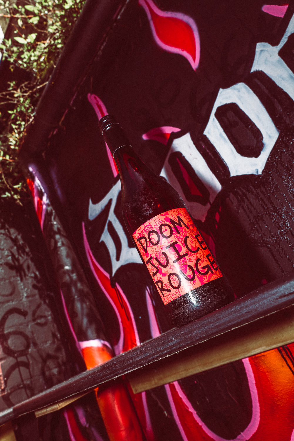 Bottle with a colorful label on a red and black background