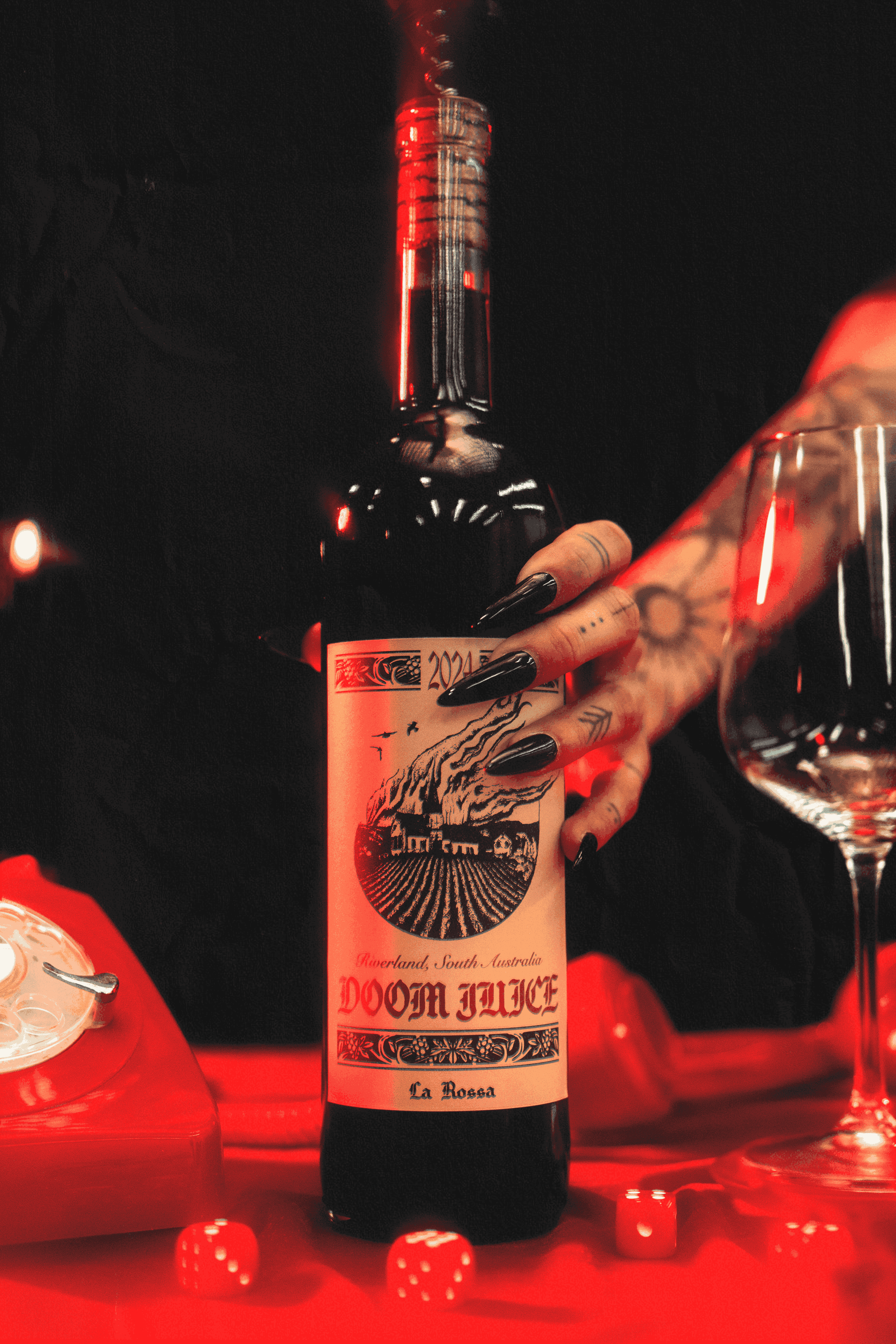 Bottle of Doom Juice with a tattooed hand holding it, set against a dark background.