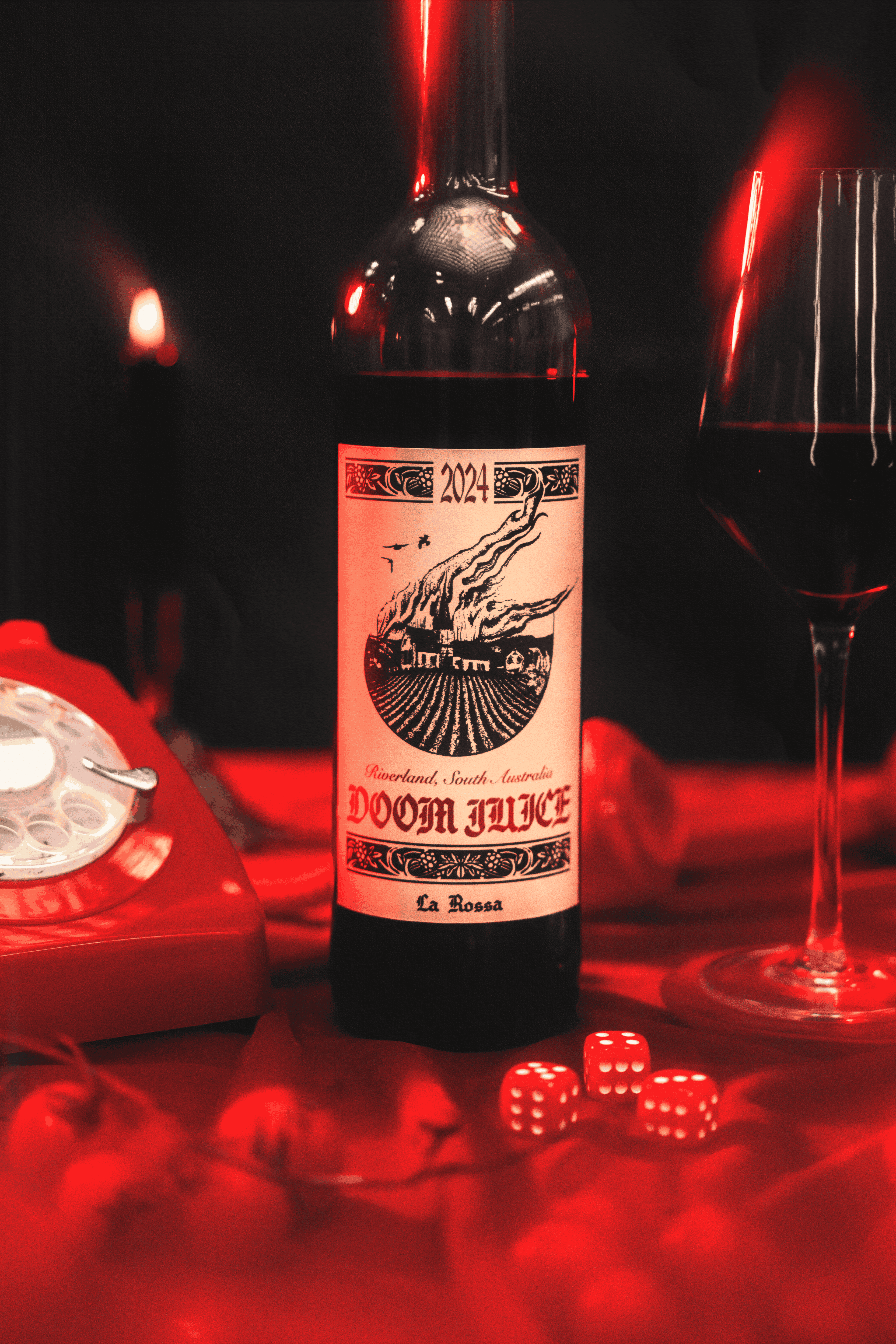 Bottle of 'Doom Juice' wine with a glass and dice on a dark background